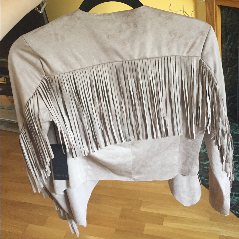 Tan jacket with fringes on the backside