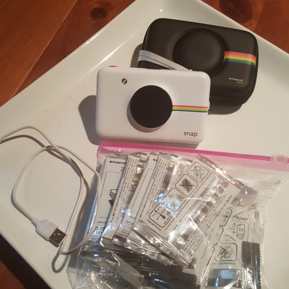 Polaroid camera/a photo both in your hand