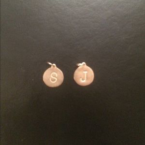 Gold charms 's' and 'j'