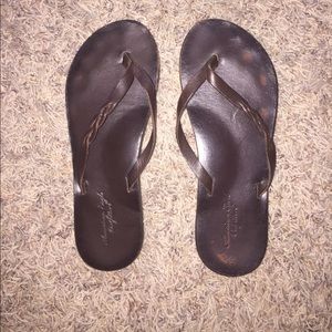 Brown leather flip flops