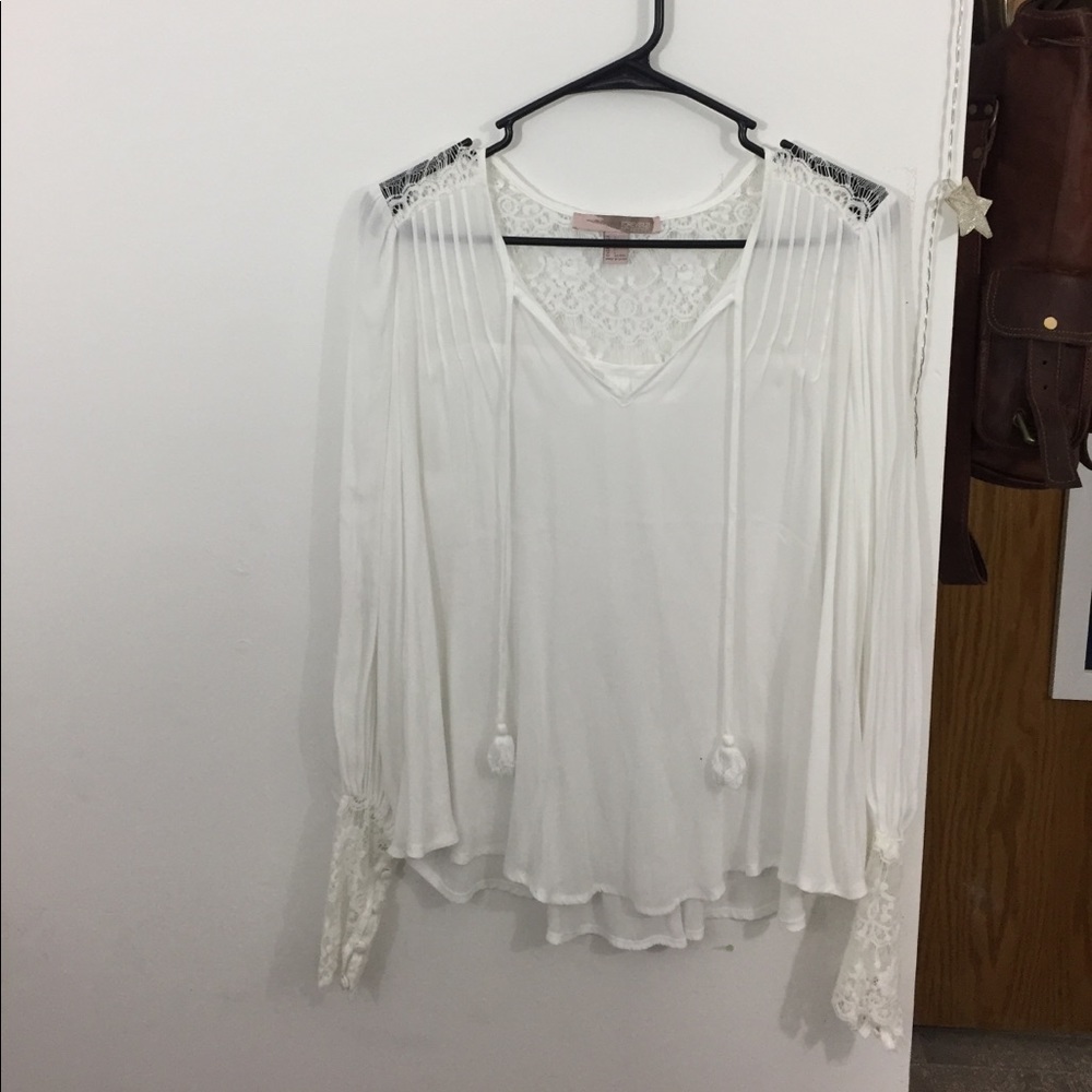 Flowing white blouse with lace detailing