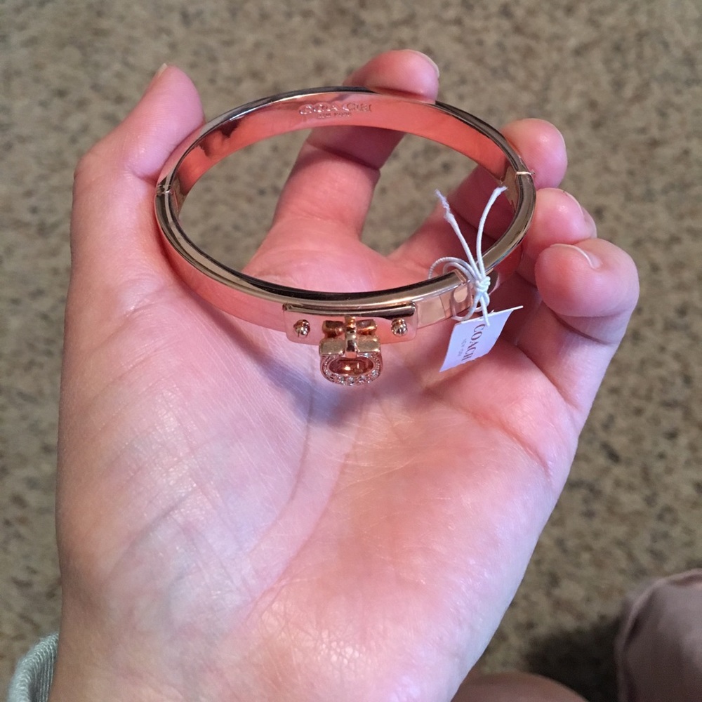 Coach rose gold bangle with a crystal "C" charm