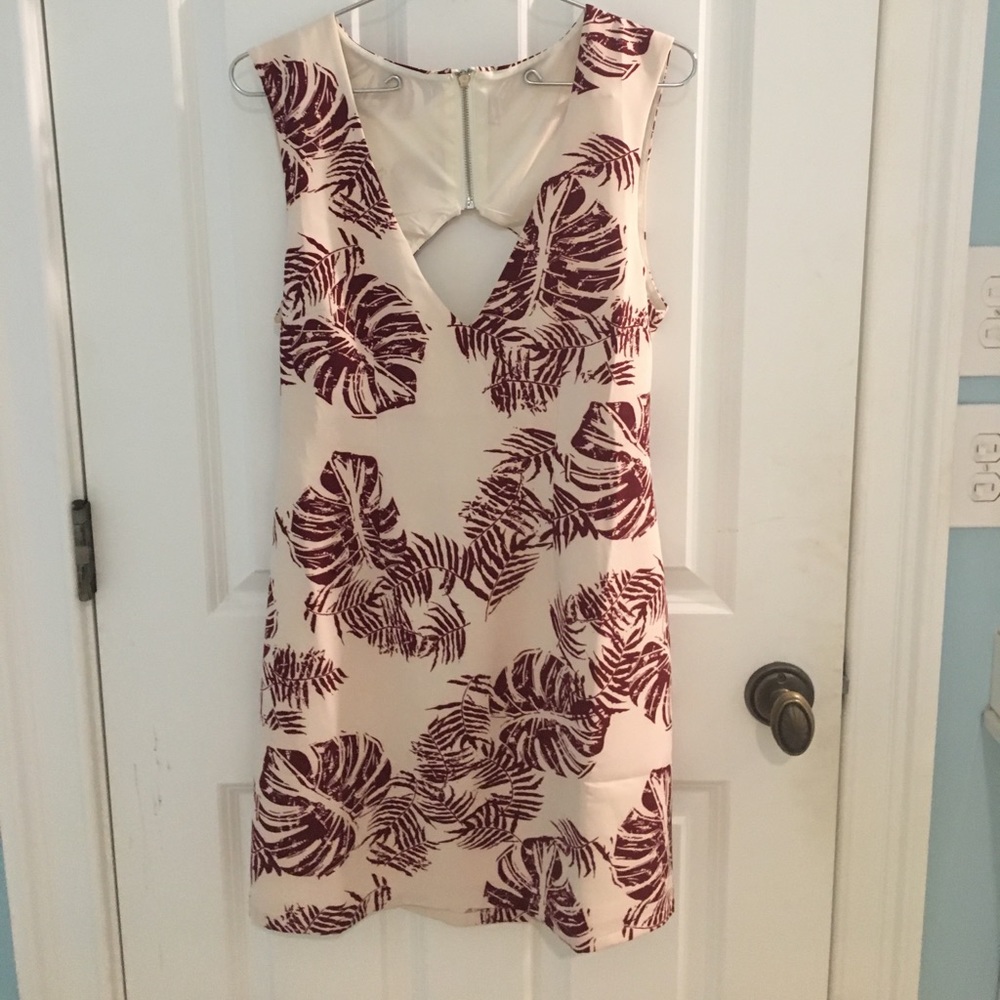 A light pink/cream dress with a leafy pattern