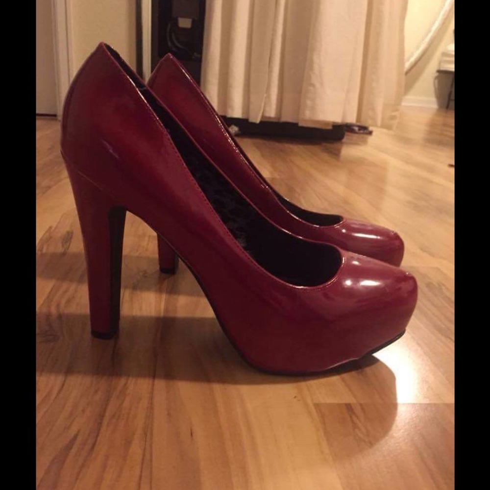 Shiny deep red platform pumps by Guess, size 9.5