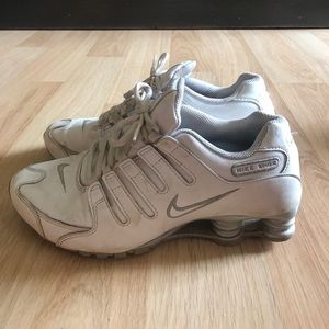 White and grey Nike shox.