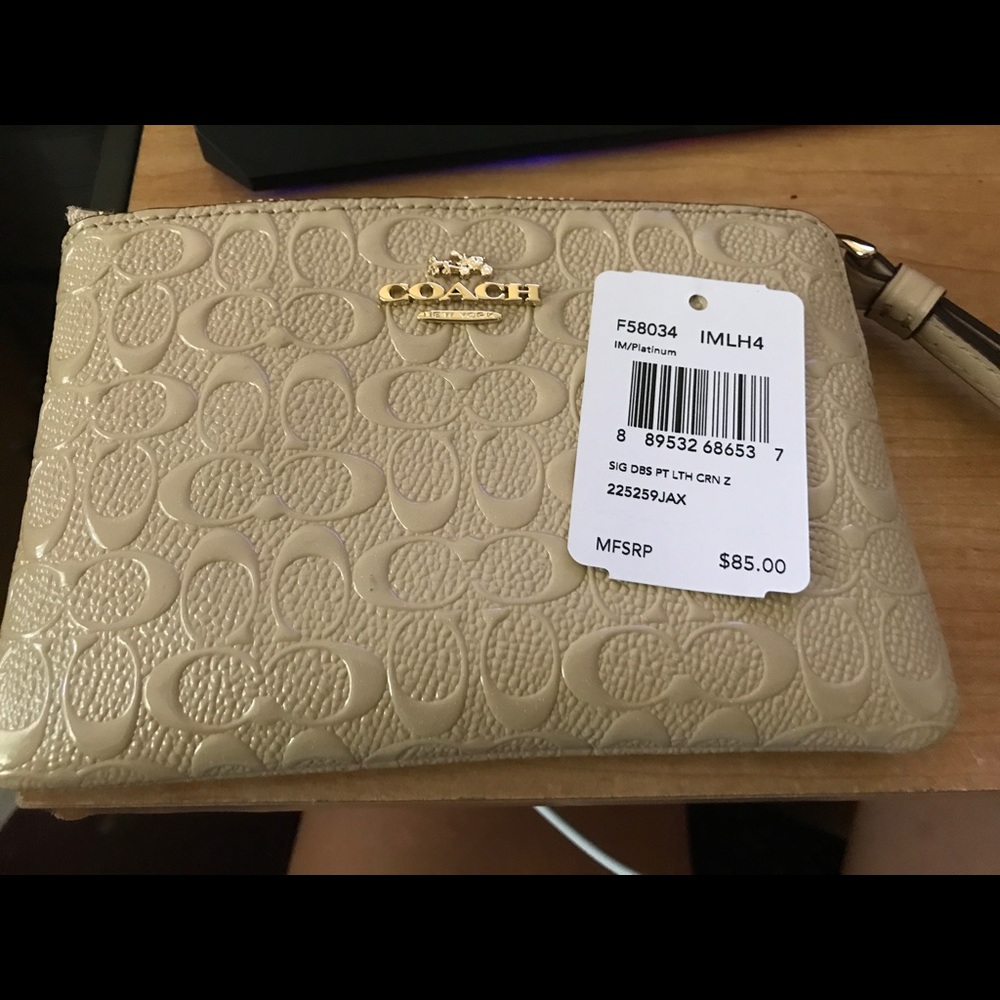 Coach beige Zip wristlet .