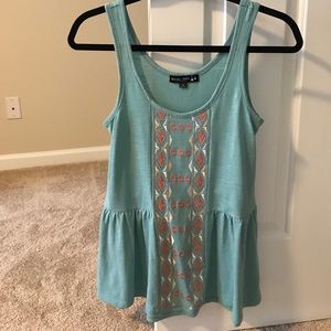 Embroidered front peplum style tank