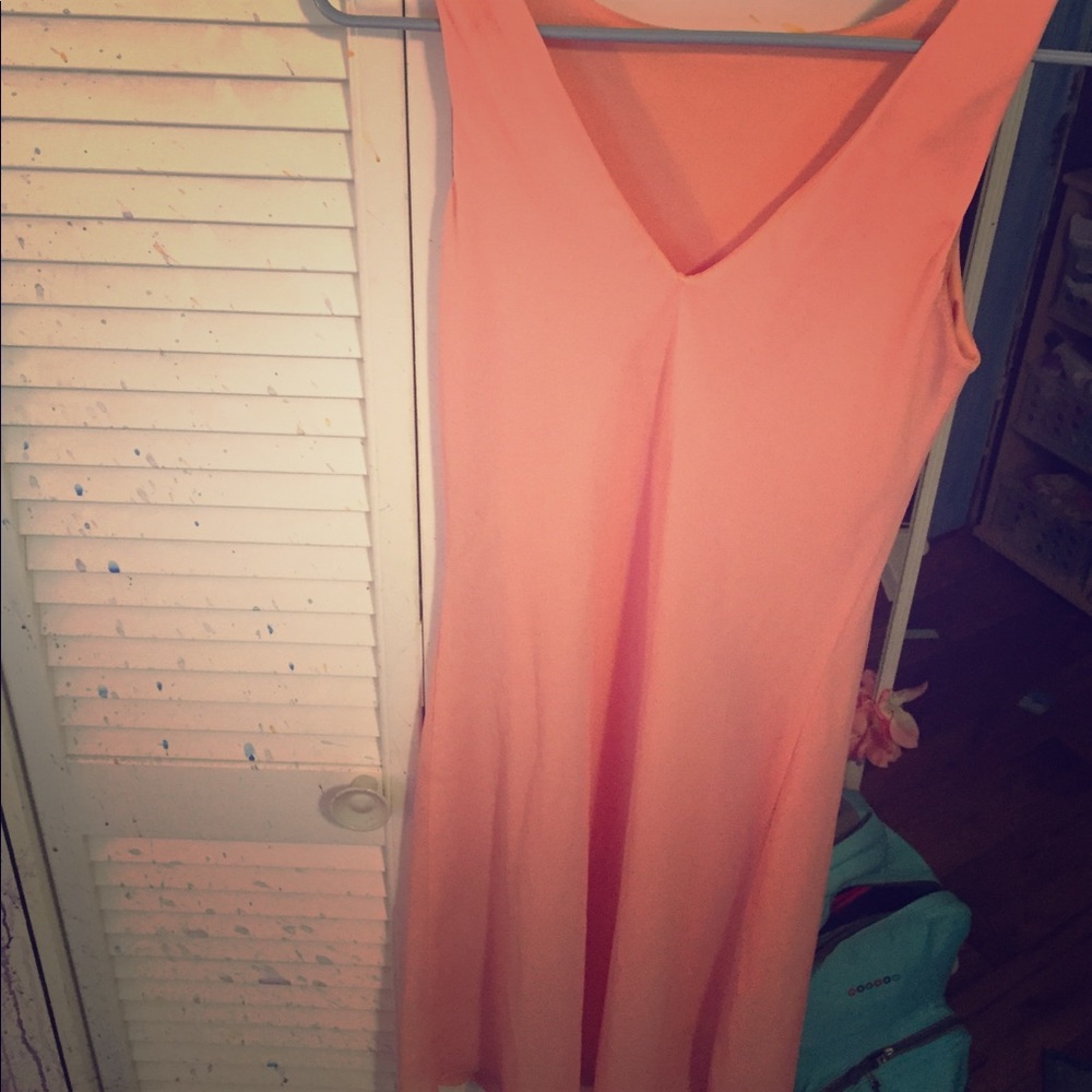 A long peach dress, below knees.