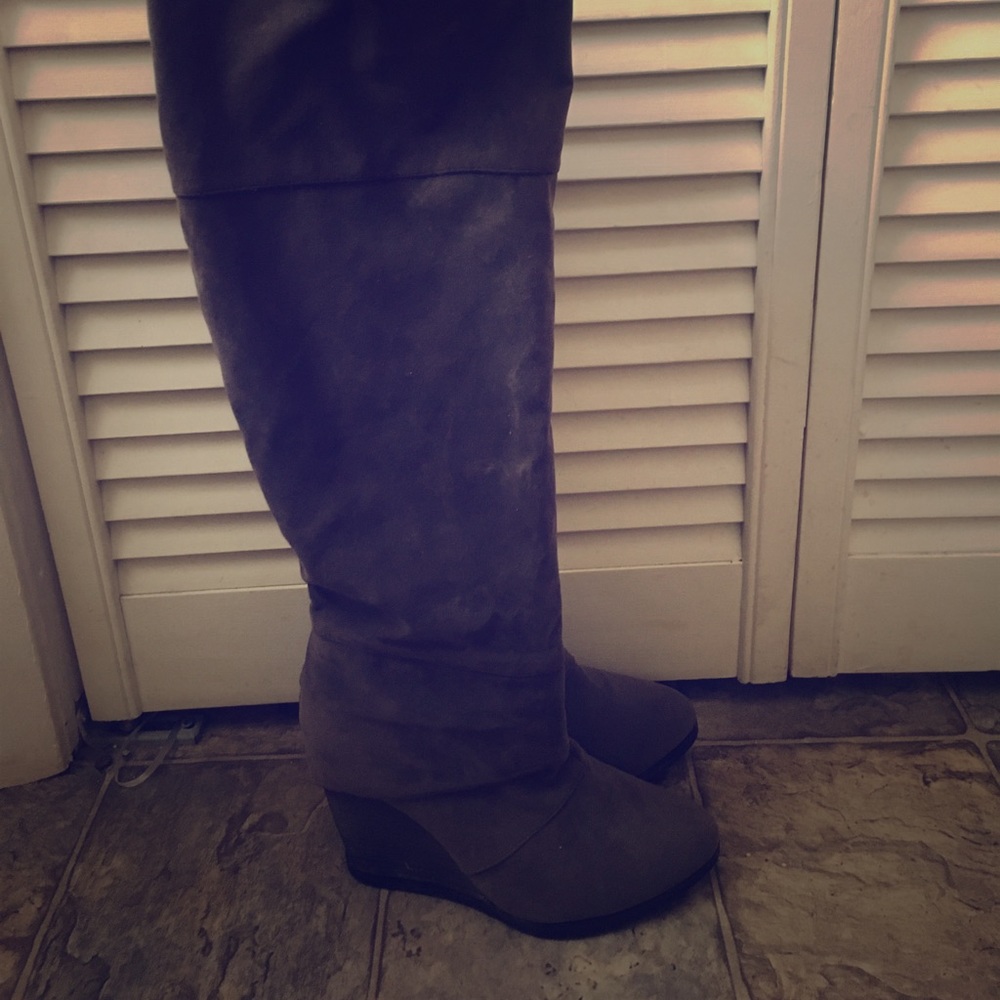 Gray knee high boots.