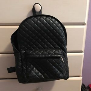 Black quilted backpack.