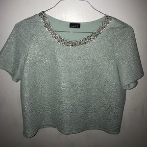 Teal crop top with an embellished neckline