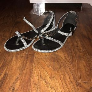 A pair of black Aldo sandals.