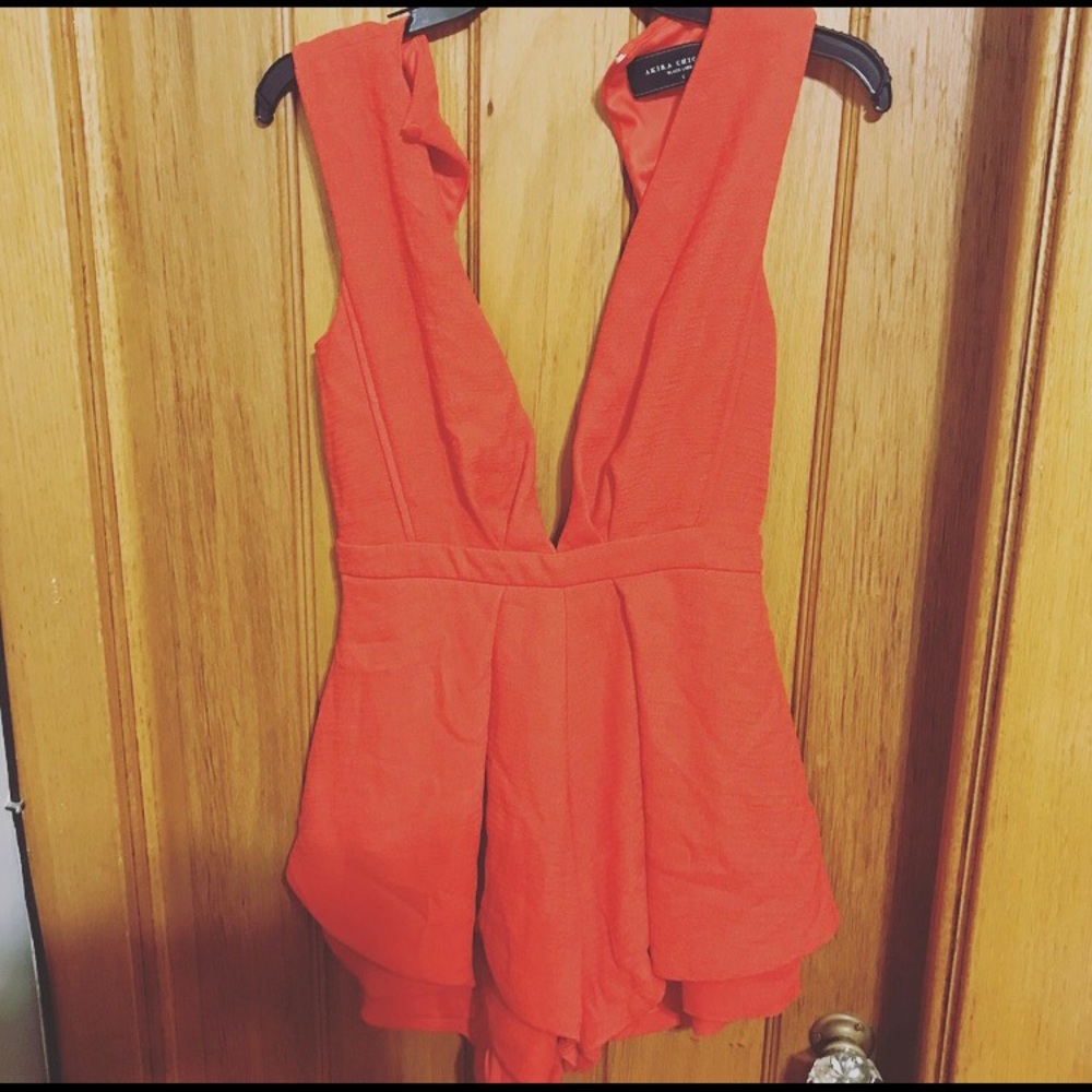 Orange deep-plunge romper. (S)