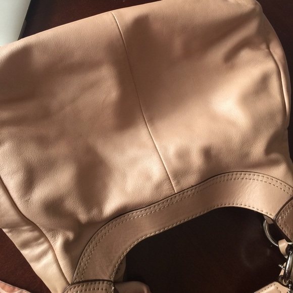 A peach colored purse. - Picture 3 of 5