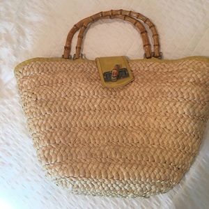 Straw bag with bamboo handles and leather trim