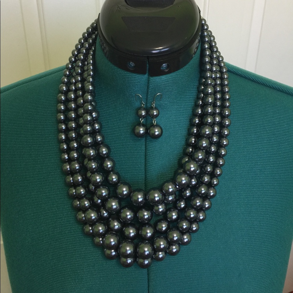 Gray faux pearl necklace with matching earrings.
