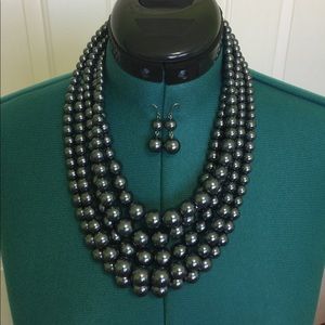 Gray faux pearl necklace with matching earrings.