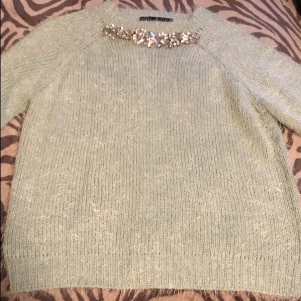 Sweater with build in necklace.