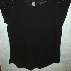A Black tshirt with gold specks on the shoulders