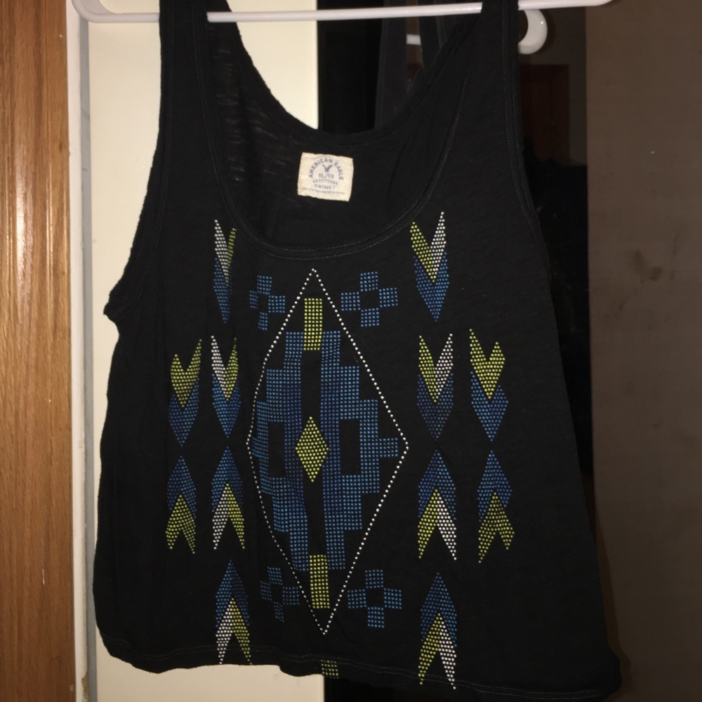 black tank top with various blue and green designs