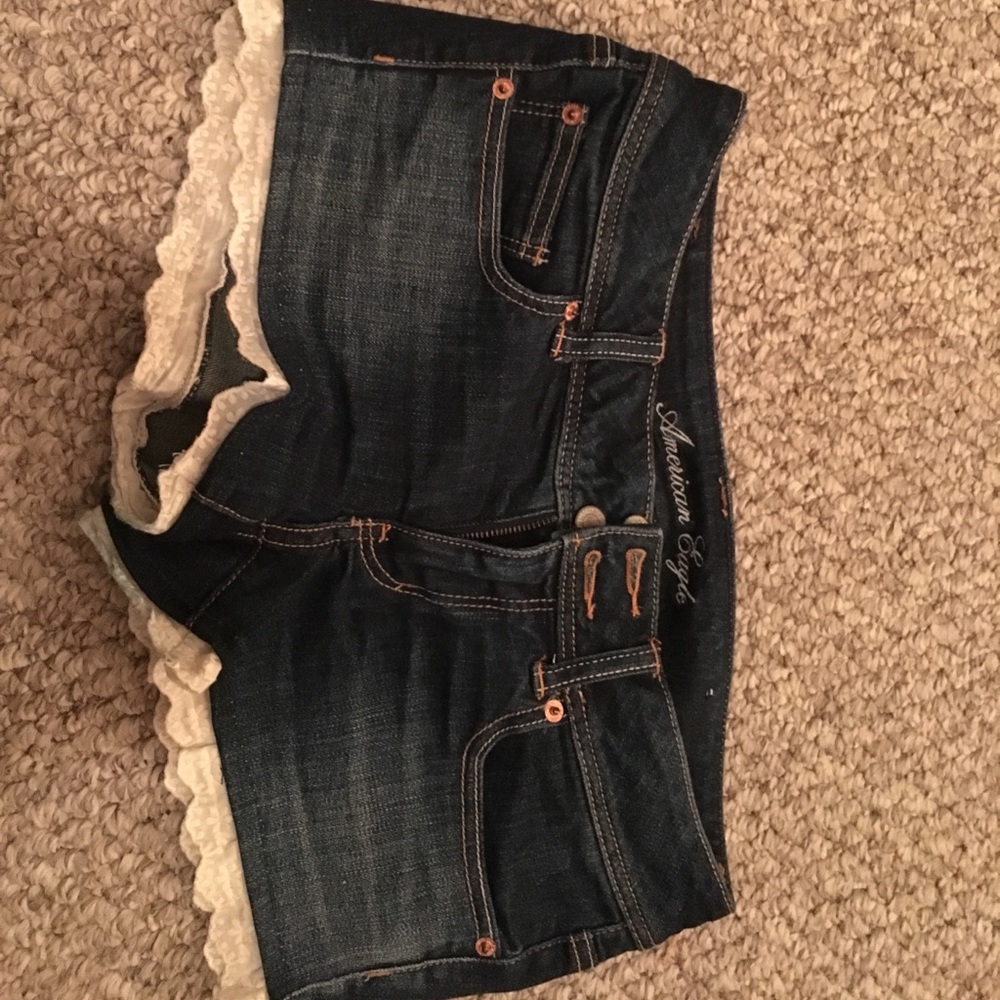 Dark wash shorts. Lace detail on bottom.