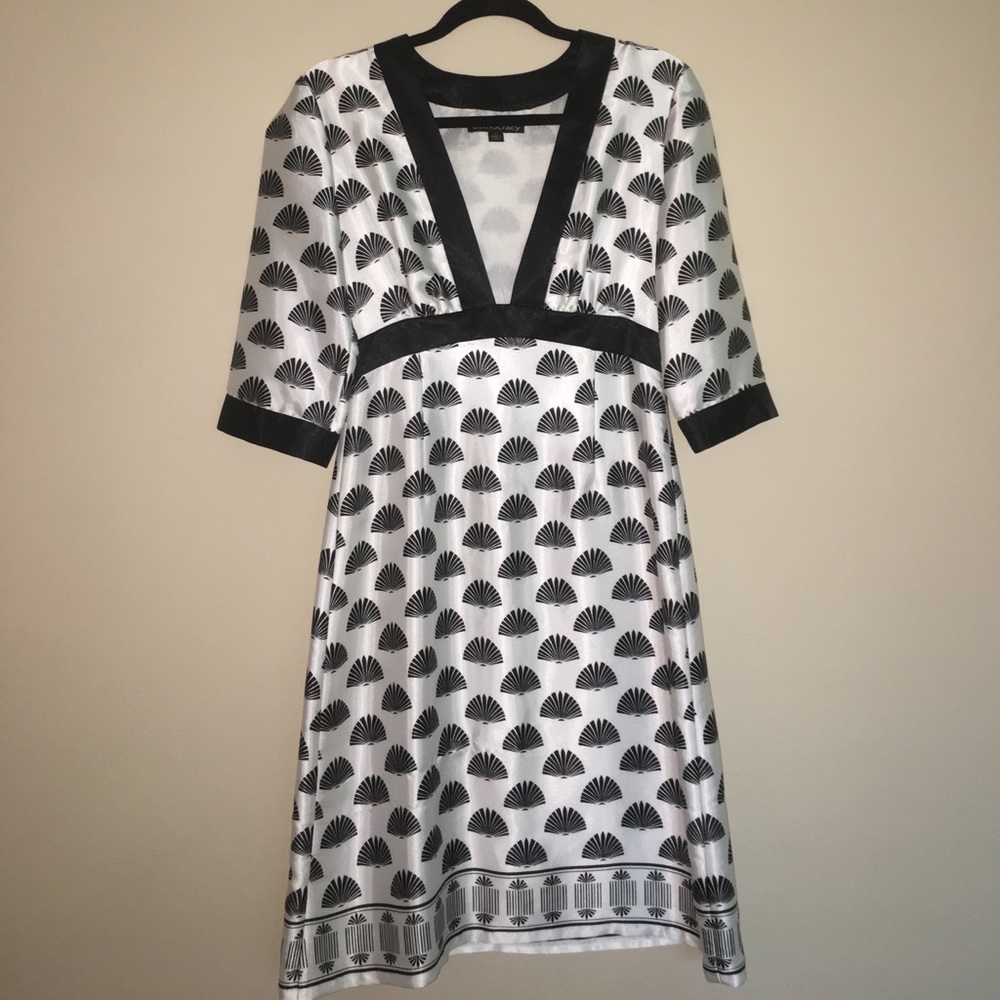 Silky black and white dress sits mid calf