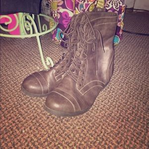 Brown lace up boots.