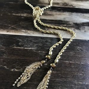 Large gold cable chain necklace with tassels.