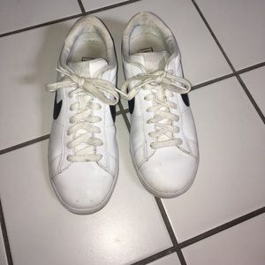 slightly worn nike tennis shoes