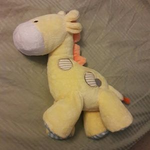 Plush musical giraffe winds up plays music.