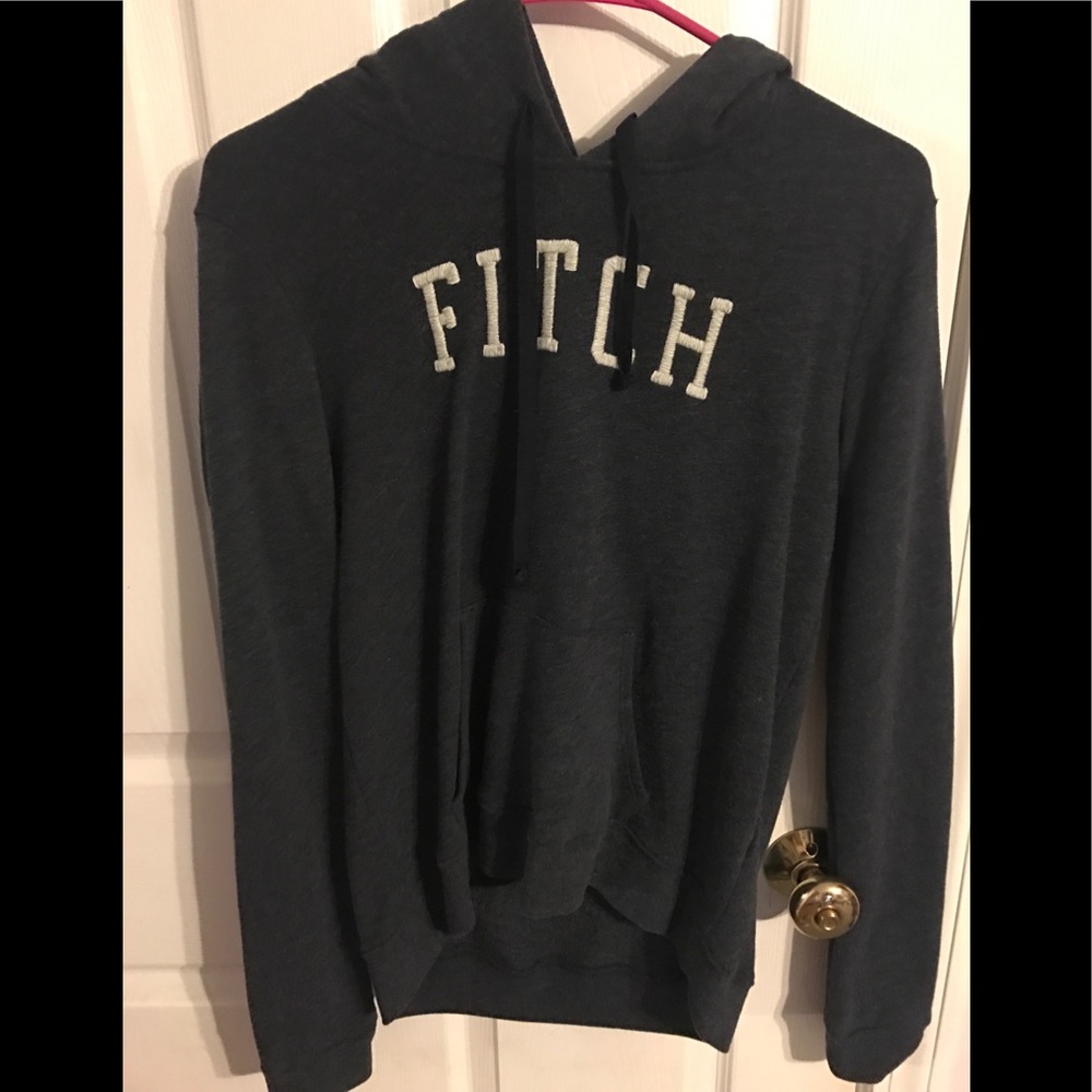 Dark grey hoodie/sweatshirt.