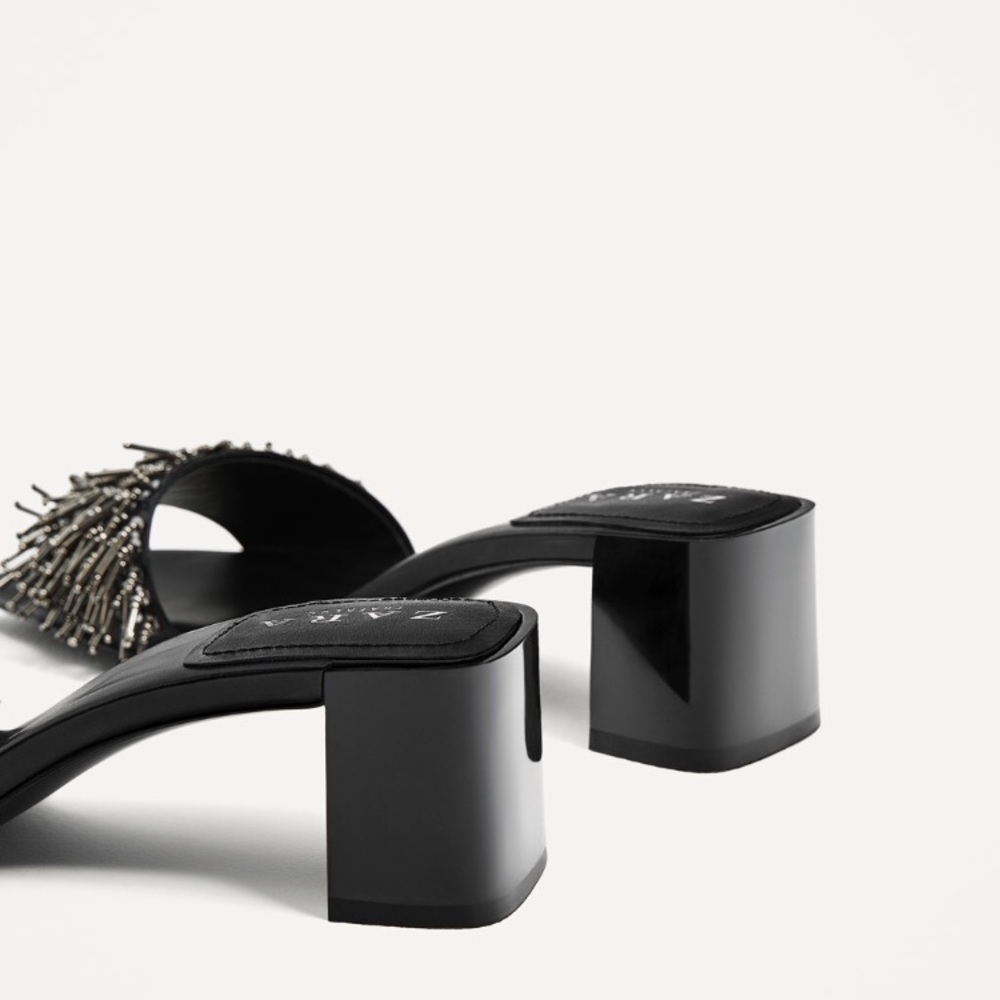 Black high heel sandals .