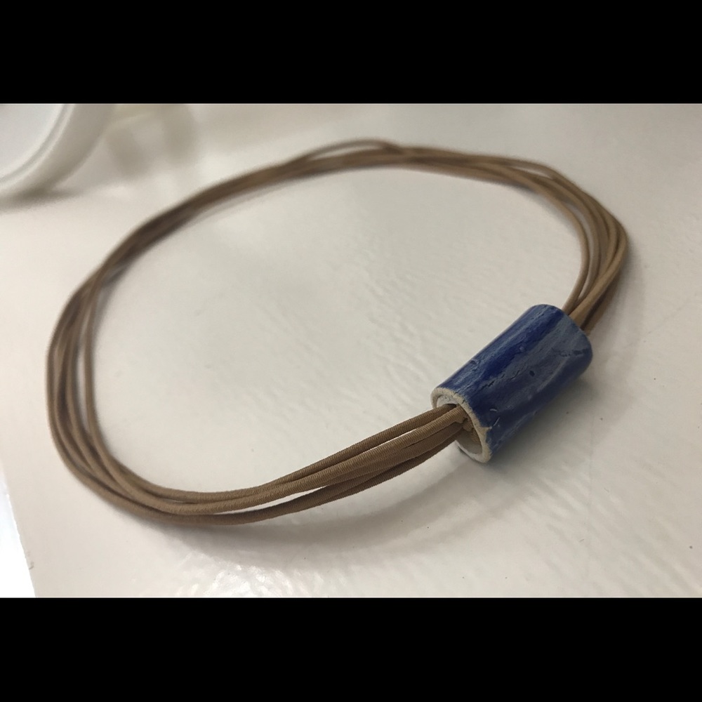 Handmade ceramic necklace.