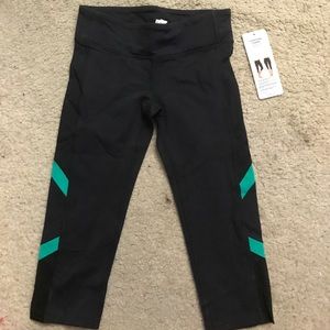 Alo Capri black yoga pants w green and mesh panels