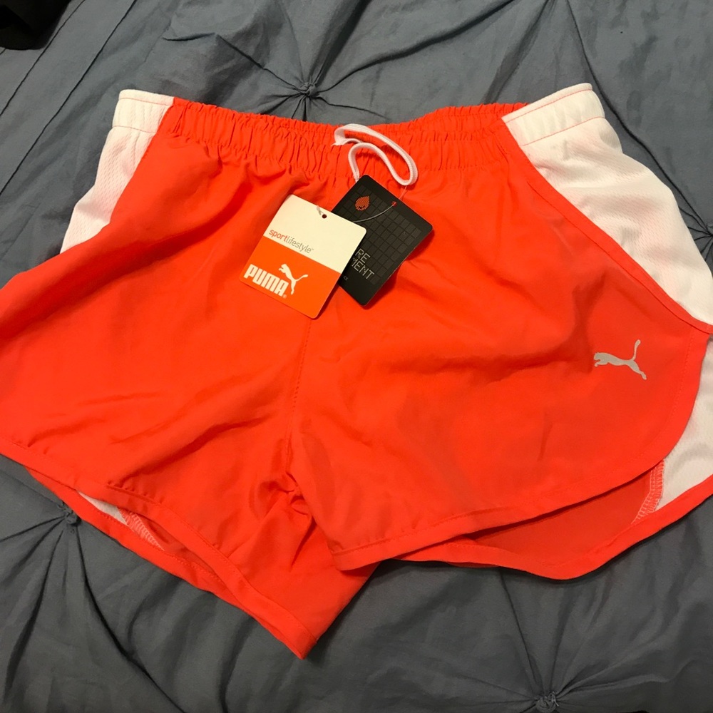 Orange and white Puma running shorts