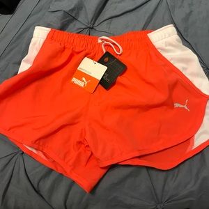 Orange and white Puma running shorts