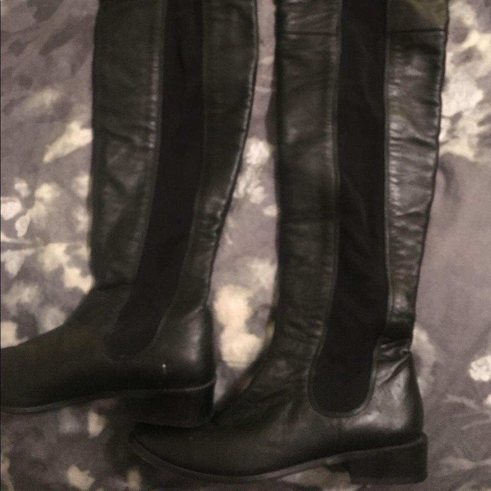 Over knee black leather boots.