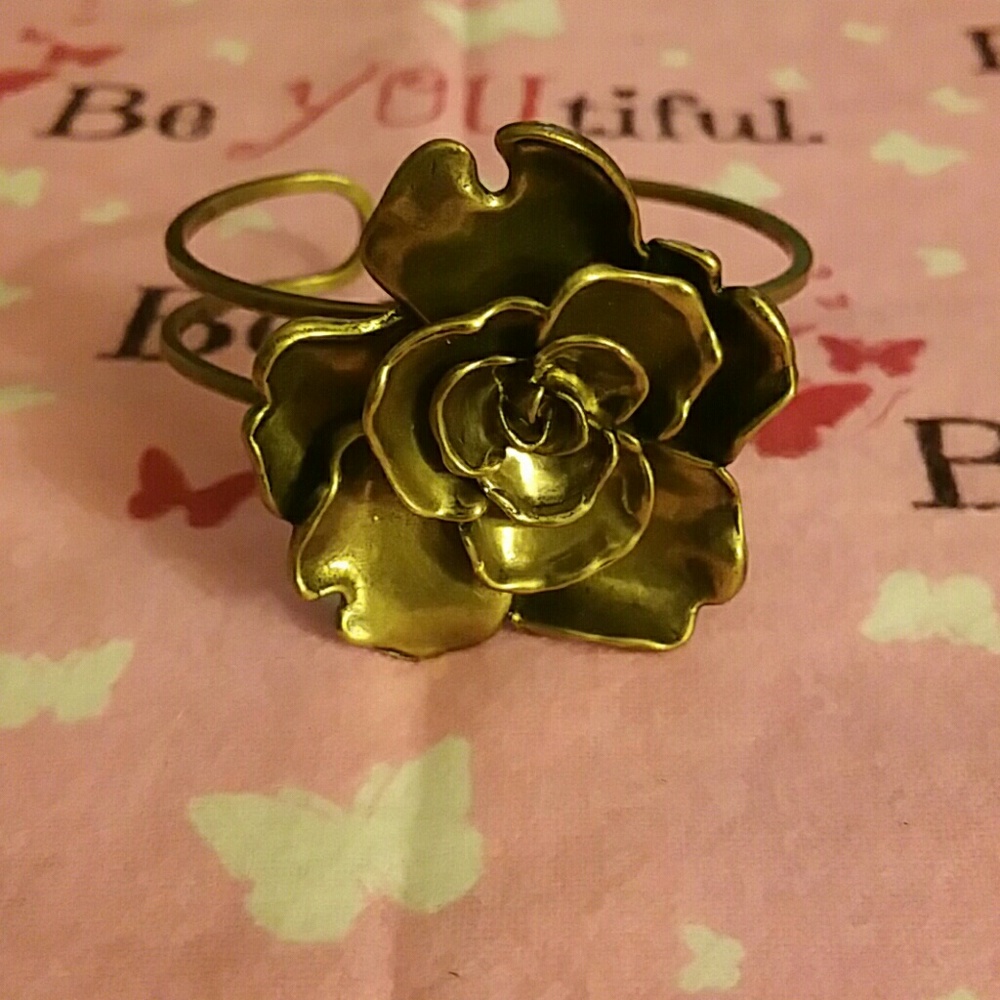Brass colored/antique gold NWOT cuff with a rose