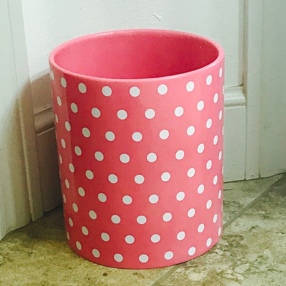 A toothbrush holder, Kleenex holder, and trashcan.