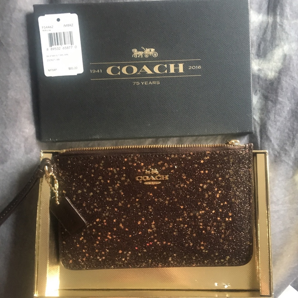 Coach wristlet purse. Gold stars.  Brand new!!