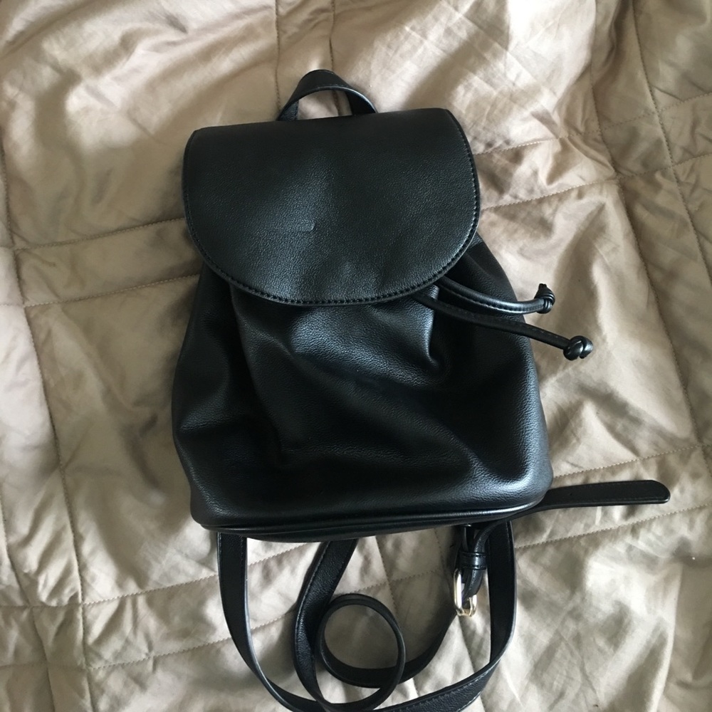 Very small black faux leather drawstring backpack