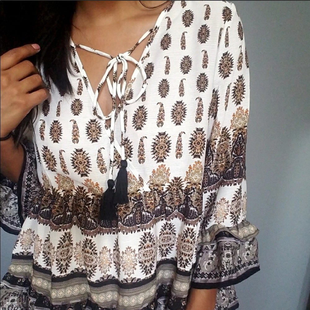 Very pretty flowy shirt with a tie in the front.