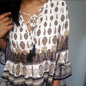 Very pretty flowy shirt with a tie in the front.