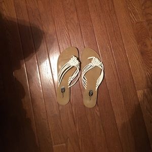 White and tan flip flops