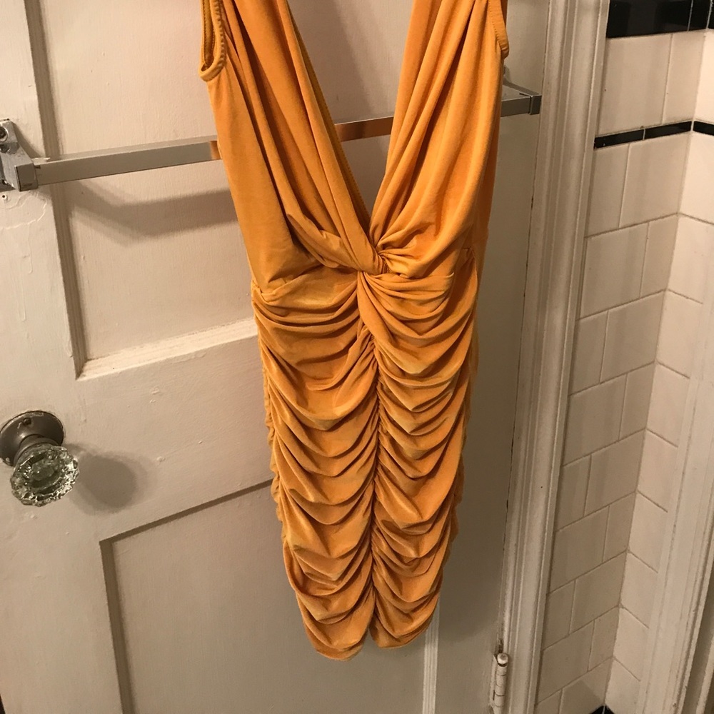 A  mustard yellow tight fitted dress
