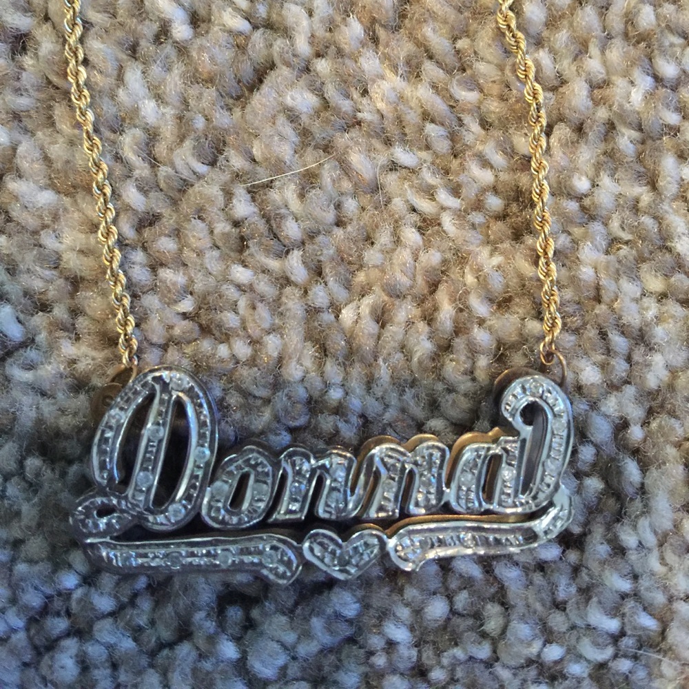 Gold and diamond name plate necklace.