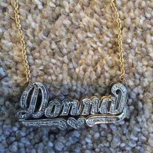 Gold and diamond name plate necklace.