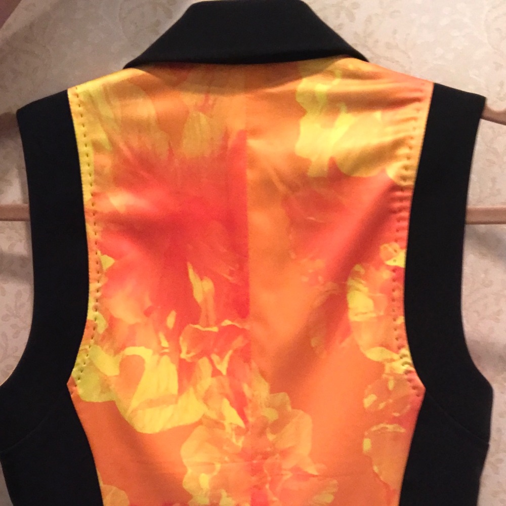 Black vest with multi colored back.
