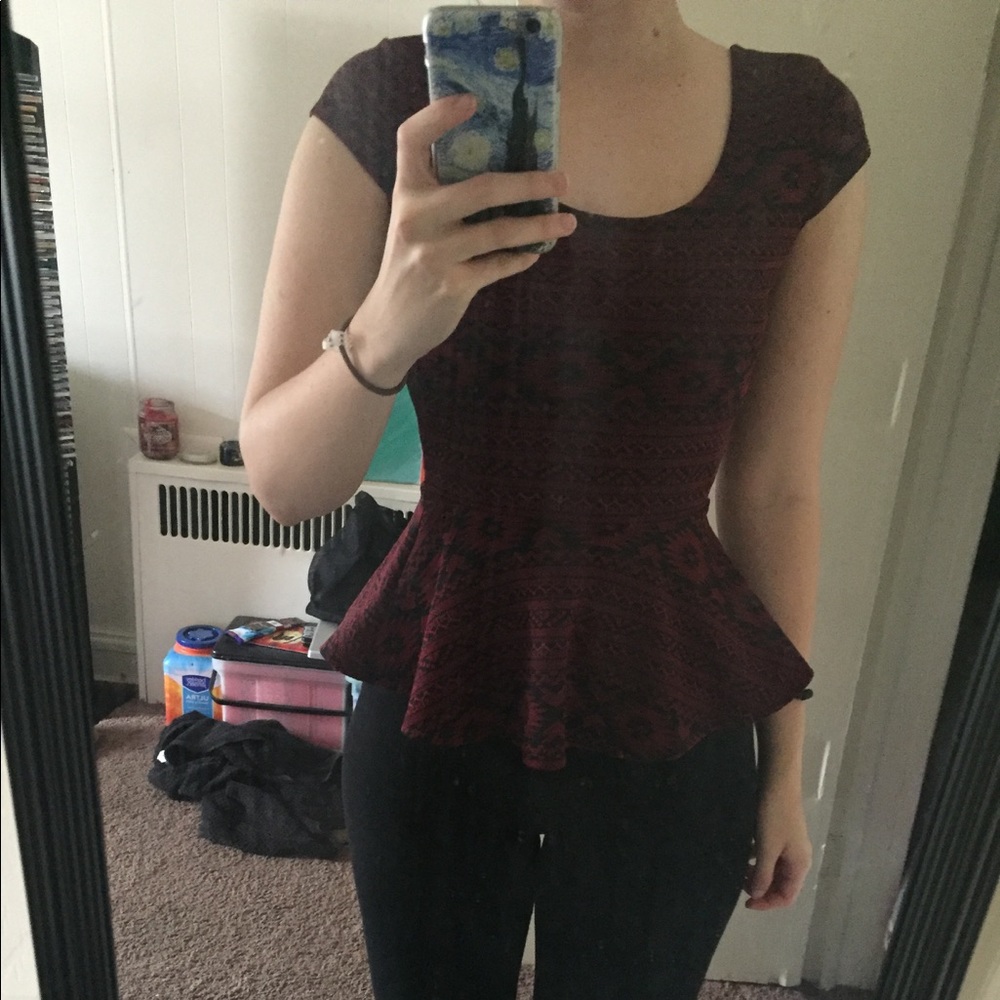 Red peplum shirt with black detail and open back