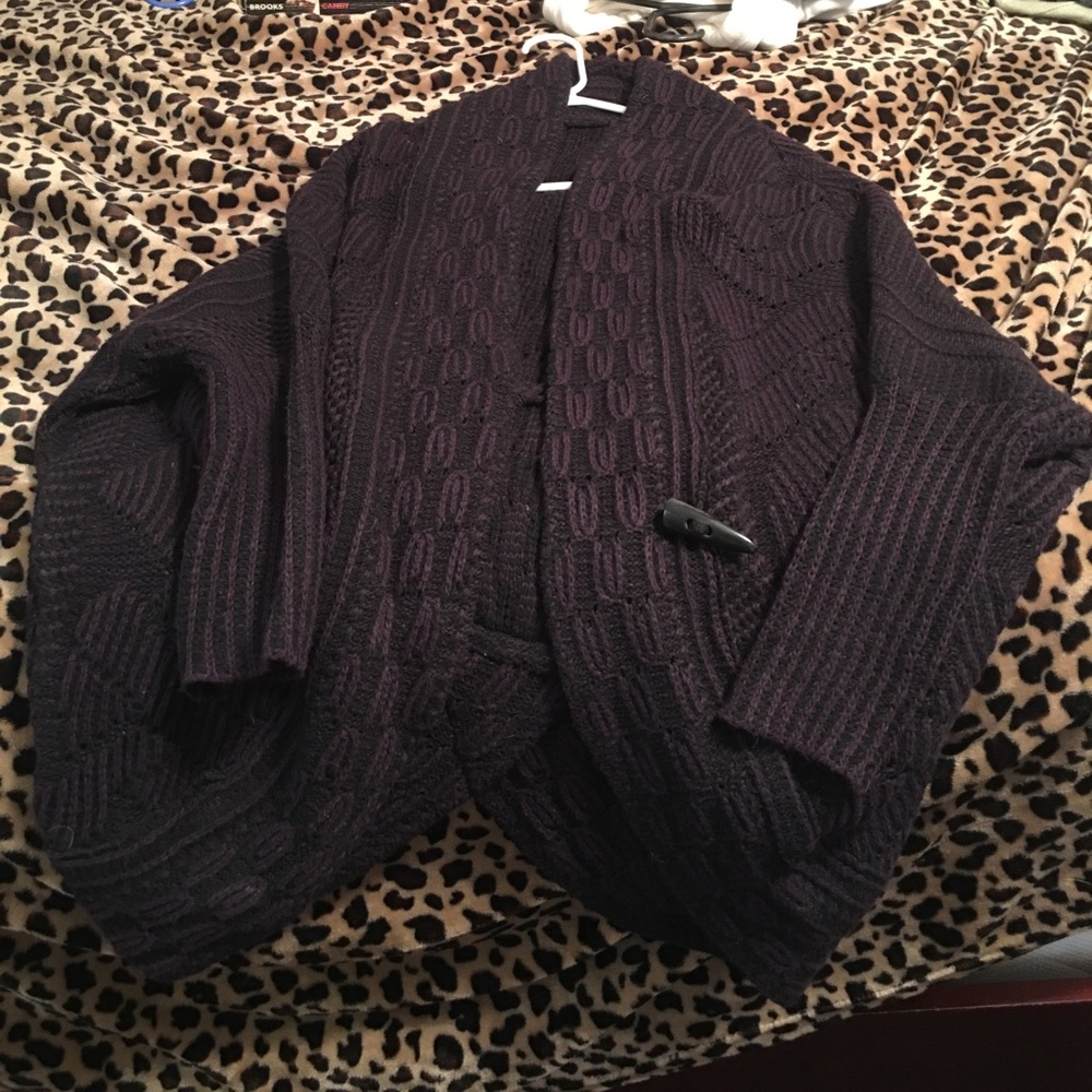 Purple and black sweater.